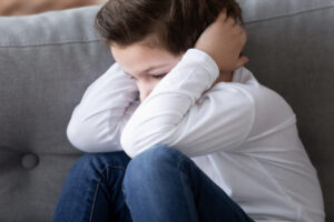 Little Boy hiding from abusive parents